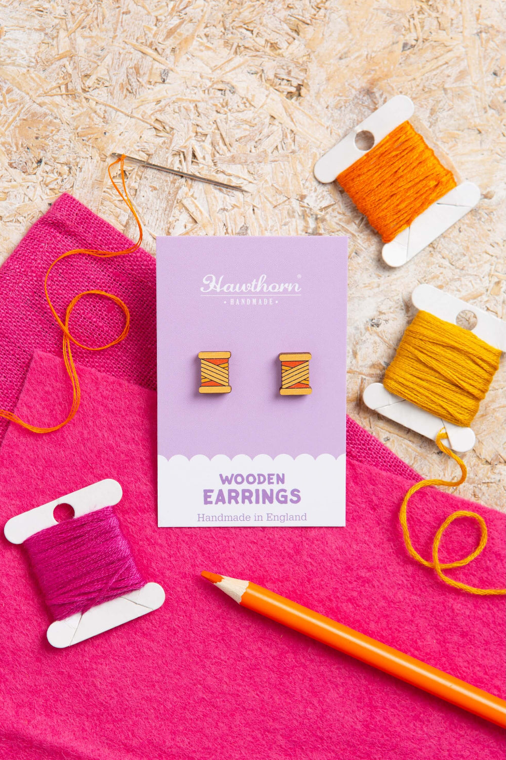 orange bobbin wooden earrings with yarn