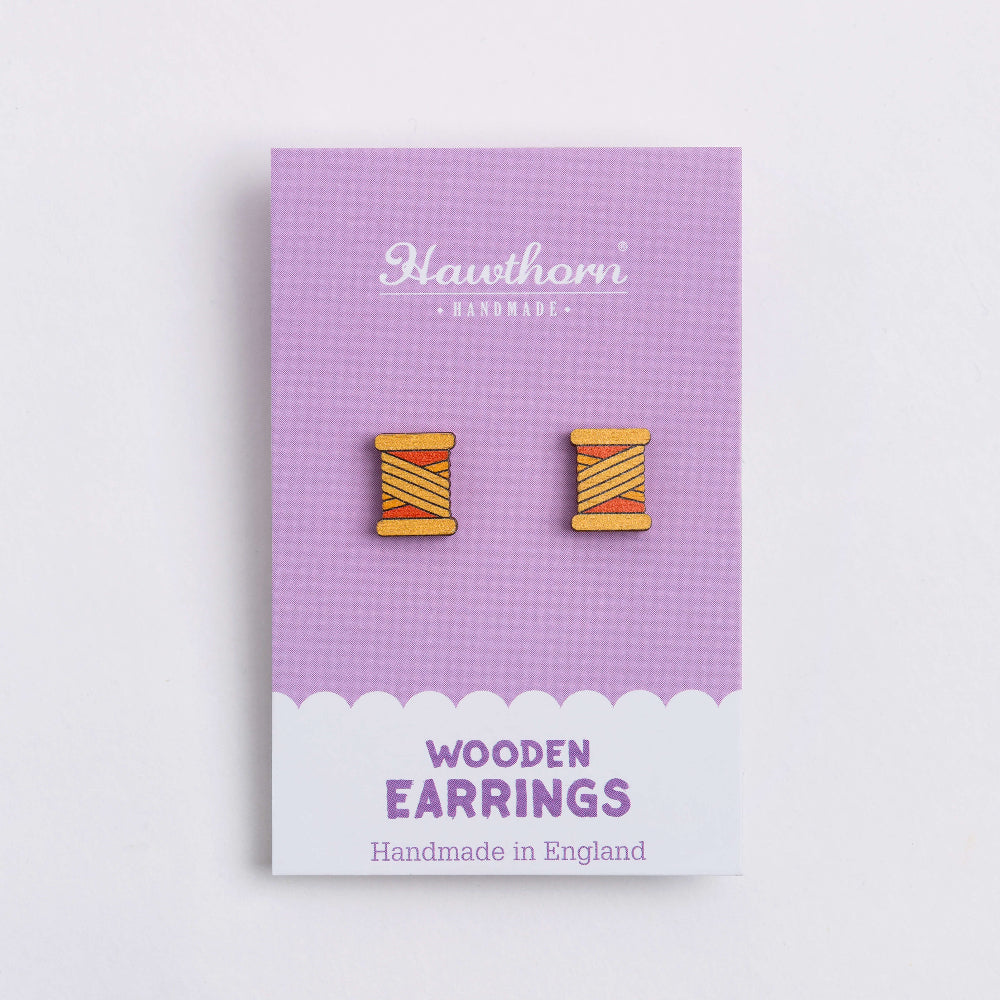 orange bobbin wooden earrings on card