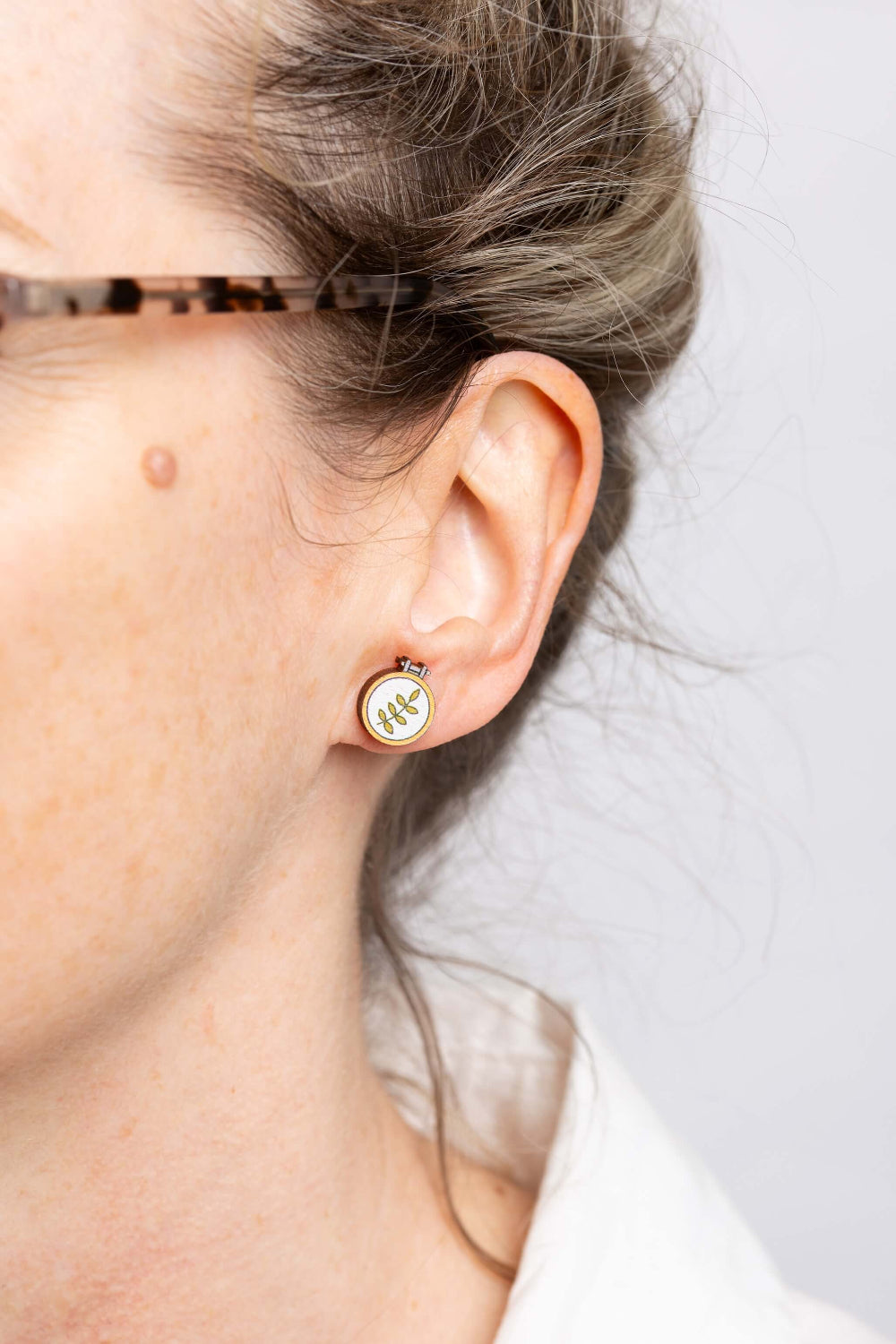 embroidery hoop botanical wooden earrings on ears