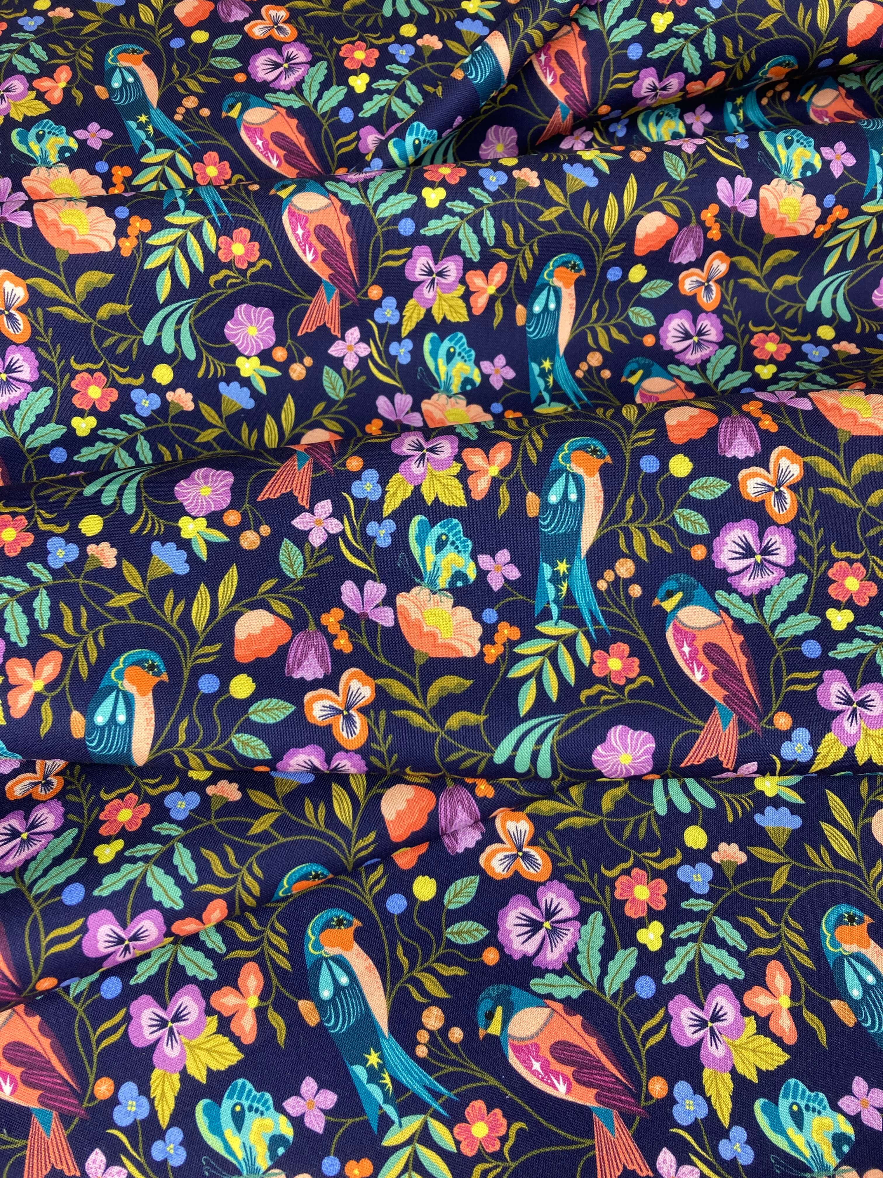 Colorful pattern of birds and flowers on a dark blue background