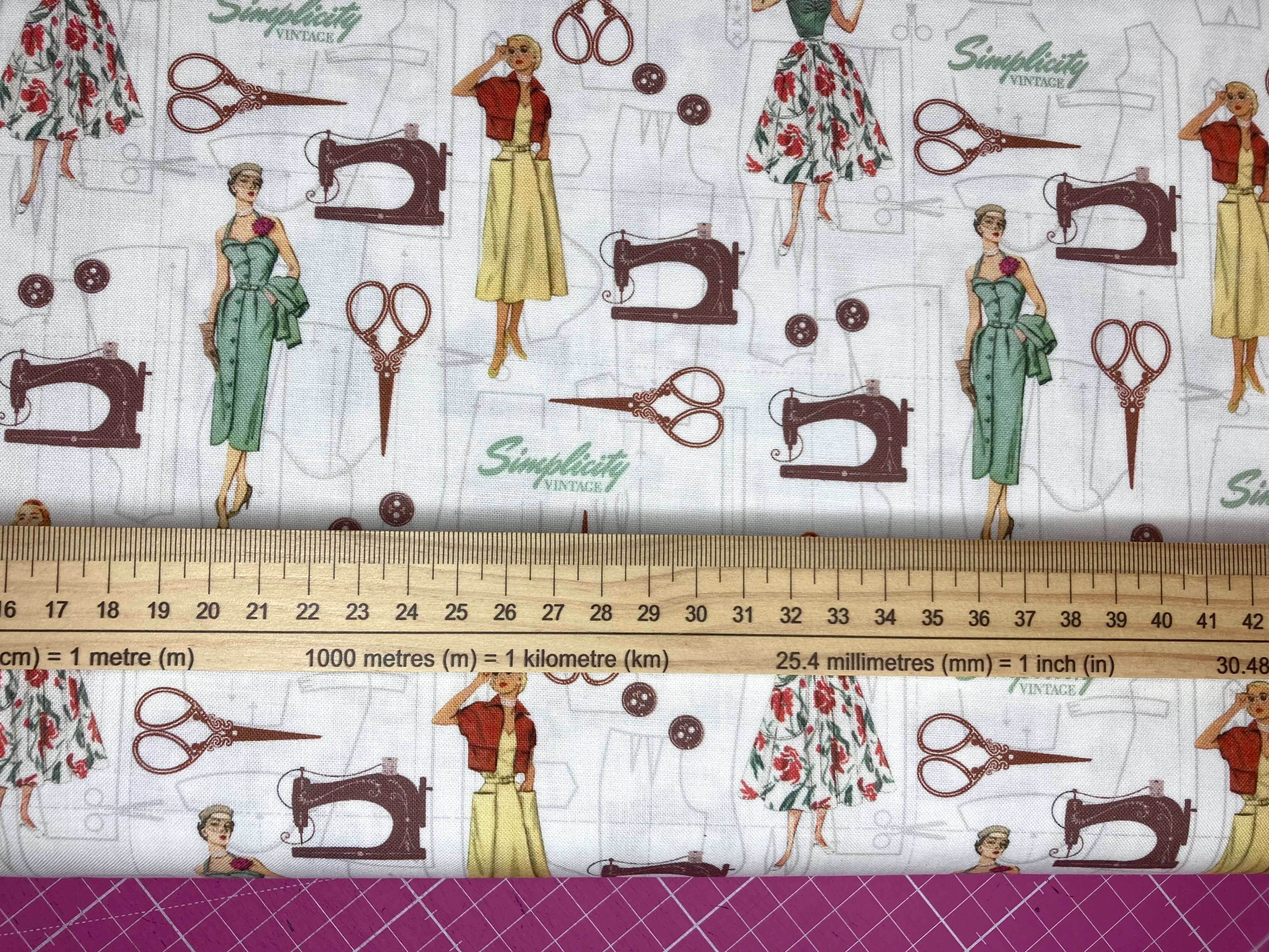 Fabric with vintage sewing-themed design featuring women, sewing machines, and scissors on a white background.