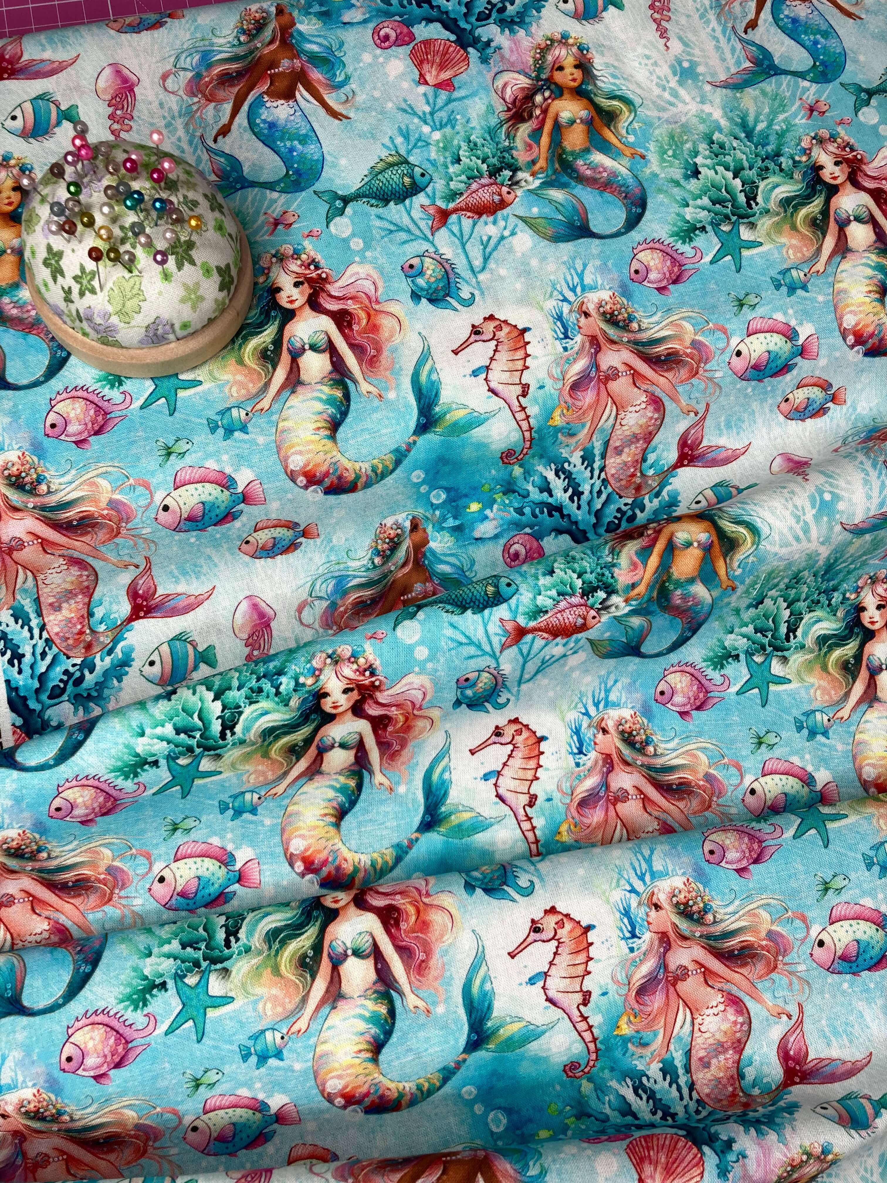 cute mermaids and fish on an aqua blue backdrop