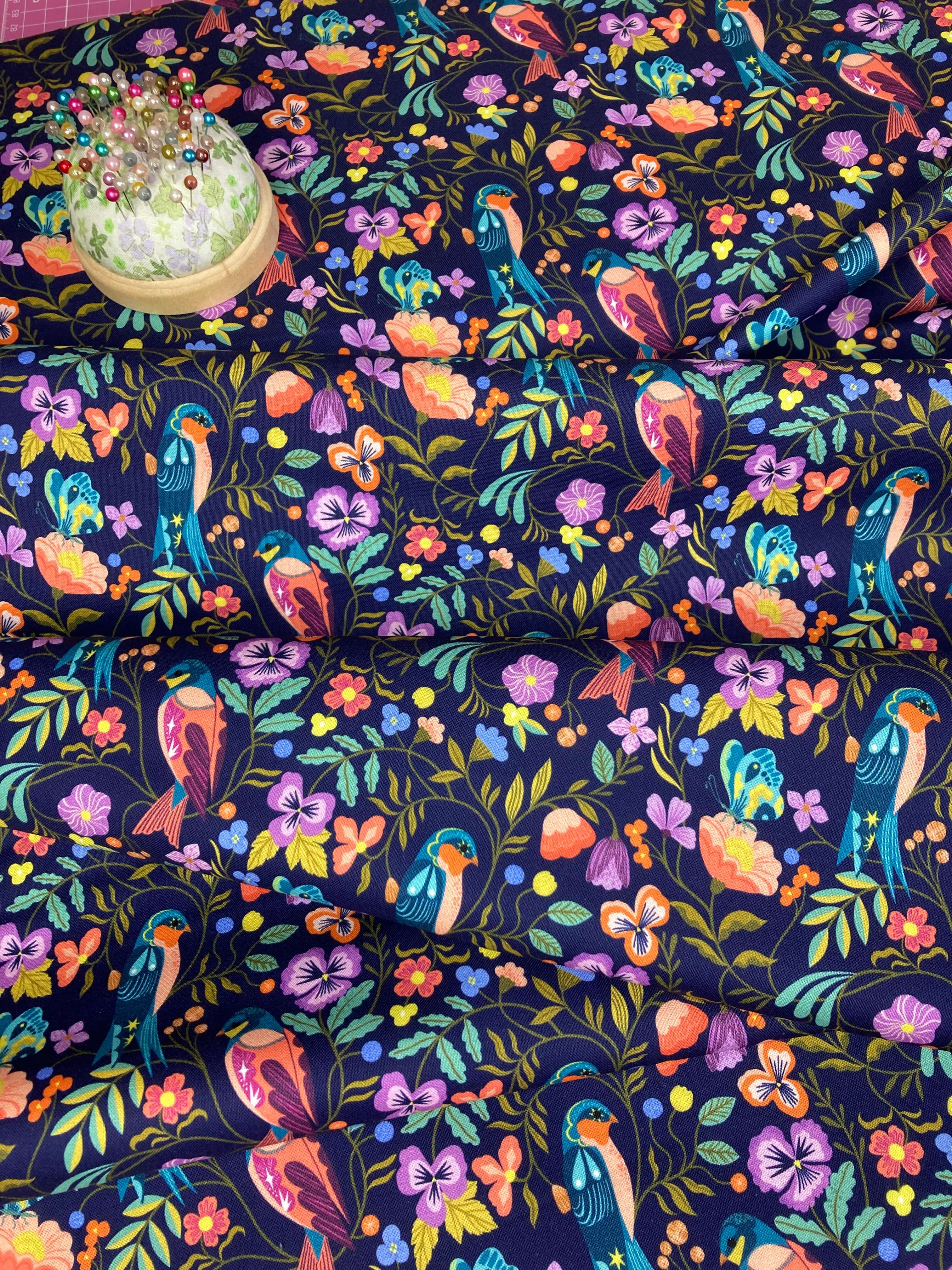 Colorful pattern of birds and flowers on a dark blue background