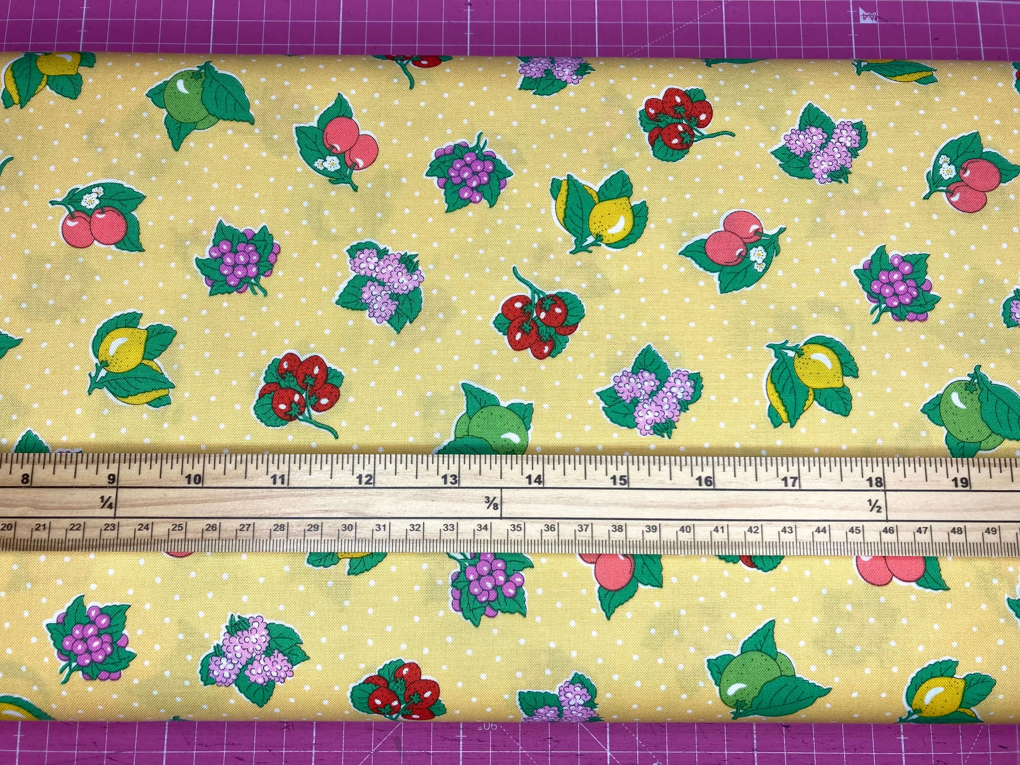 yellow cotton fabric with white polka dots and colourful fruit
