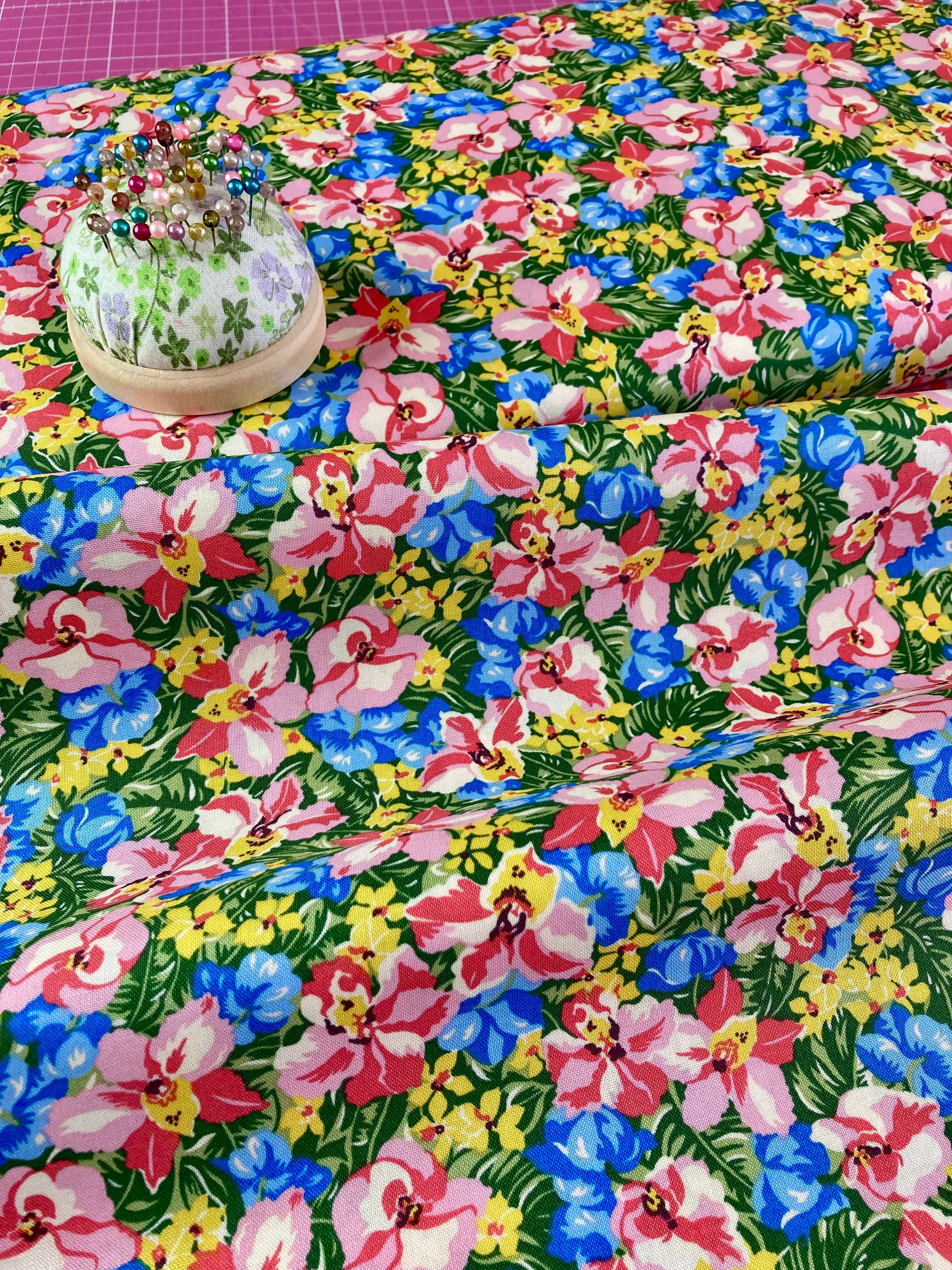 vibrant tropical floral liberty print fabric with blue pink and yellow flowers