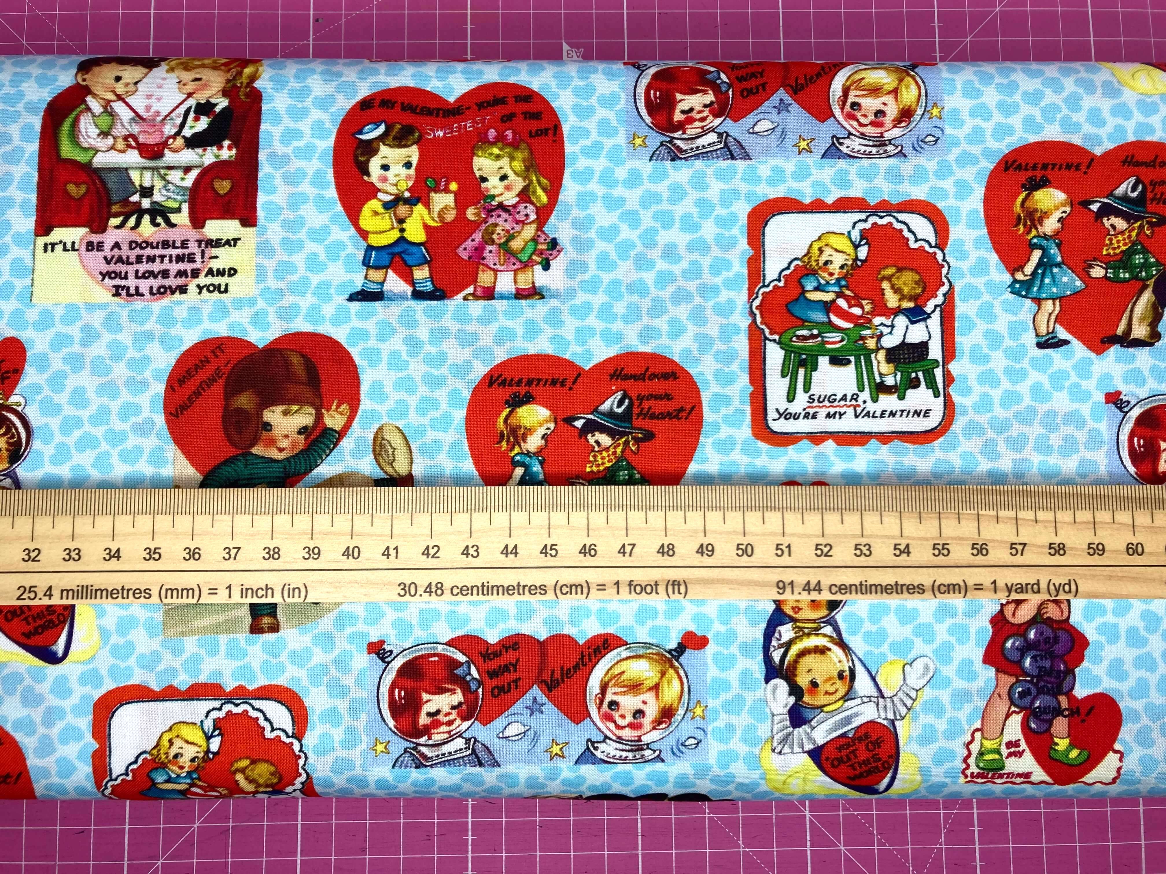 blue speckled fabric with retro love hearts and love messages with a ruler
