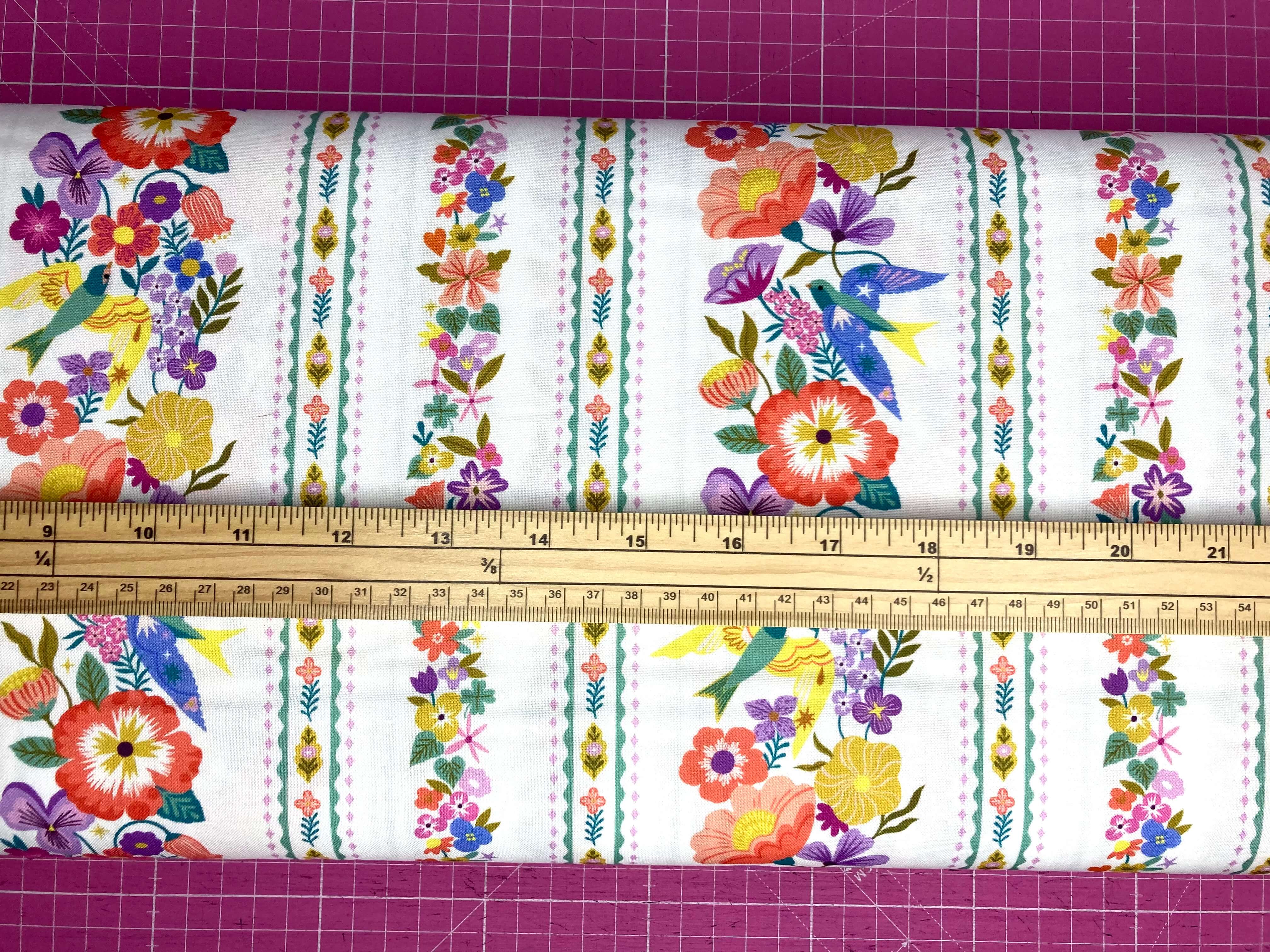 Decorative floral fabric with colorful flowers and birds on a white background